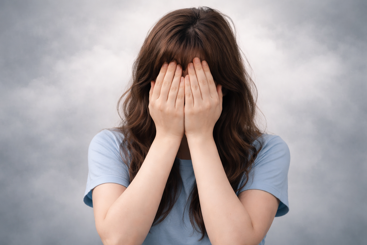 Femme cachant son visage avec ses mains symbolisant la honte et un manque d’estime de soi